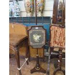 A Regency rosewood pole screen, the floral woolwork panel on a reeded stem and platform base with