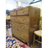 An early 19th century mahogany chest of drawers with two short and three long graduated drawers on