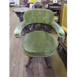 A late Victorian carved walnut swivel office chair, the button upholstered back on C-scroll supports