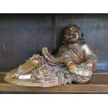 A Chinese hardwood figure of a reclining man with bats and basket 33cm long