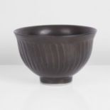 David Leach (British, 1911-2005) Small Fluted Bowl Porcelain, dark brown glaze over a delicately