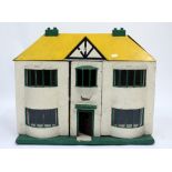 AN EARLY TO MID 20TH CENTURY HANDMADE DOLL'S HOUSE with yellow painted roof, 96cm wide