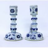 A PAIR OF ANTIQUE CHINESE PORCELAIN BLUE AND WHITE CANDLESTICKS with lobed stems and octagonal