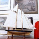 A PAINTED WOODEN MODEL OF A TWO MASTED YACHT 122cm long x 118cm high