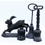 A SMALL BRONZE SCULPTURE OF A RABBIT 21cm high together with three various door stops or porters (