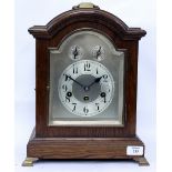 A GERMAN OAK CASED TABLE CLOCK with domed top and brass carrying handle, the dial with Arabic