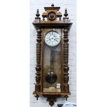 A LATE 19TH / EARLY 20TH CENTURY WALNUT CASED VIENNA STYLE WALL CLOCK with painted dial, pendulum