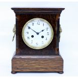 AN ANTIQUE OAK CASED FRENCH MANTLE CLOCK striking the hours on a gong, 21.5cm wide x 27.5cm high