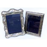 TWO 20TH CENTURY SILVER DECORATIVE PHOTO FRAMES the largest measuring 26cm x 23cm (2)