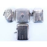 FOUR SILVER VESTA CASES with engine turned decoration / foliate engraved decoration of various sizes