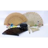 A 19TH CENTURY CARVED IVORY PARASOL HANDLE, a late 19th century lace fan, three further fans, a