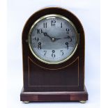 A MAHOGANY CASED DOME TOPPED MANTLE CLOCK with boxwood stringing, the silvered dial with Arabic