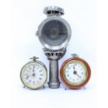 A POWELL AND HANMER 'ORACLE' OF BIRMINGHAM BICYCLE LANTERN and two vintage bedside clocks one in a