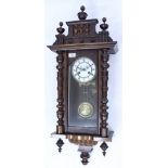 AN OLD WALNUT CASED VIENNA TYPE WALL CLOCK with musical chime, the dial signed 'Fattorini & Sons,