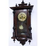 A WALNUT CASED VIENNA TYPE WALL CLOCK with turned finials 35cm wide x approximately 78cm high