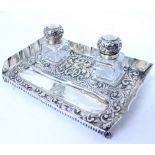 A VICTORIAN LONDON SILVER DESK STAND with repousse decoration and monogrammed detail to the pen