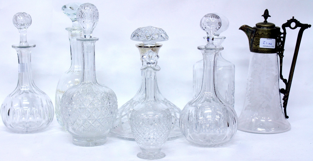 A CUT GLASS SHIP'S DECANTER with a silver collar, six further glass decanters and a claret jug