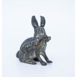 AN AUSTRIAN COLD PAINTED MODEL OF A RABBIT with a carrot, marked Gescutz to the base, 3.5cm high