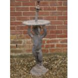 AN OLD CAST LEAD FOUNTAIN the bowl with putti support on a rocky base, 36cm diameter x 95cm high