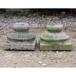 A PAIR OF CARVED INDIAN STONE PILLAR BASES with lotus flower decoration, each 30cm wide x
