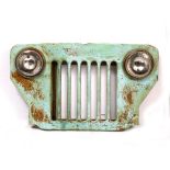 A JEEP RADIATOR GRILL painted iron and glass, 99cm wide x 59cm high x 12cm deep