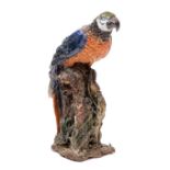 COLLIN KELLAM, A polychrome glazed pottery sculpture of a macaw on a branch perch, 75cm high (ARR)