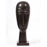 A CARVED STONE HEAD in the manner of Amedeo Modigliani, on integral square base, unsigned, 23cm wide