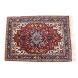 A MODERN PERSIAN STYLE RED AND BLUE GROUND RUG with stylised foliate decoration and a banded