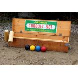 A JAQUES CROQUET SET with mallets, hoops and balls, all within a pine box with rope carrying