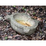 AN OLD MARBLE SINK OR MORTAR of oval form with lugs to the front, 50cm wide x 16cm high