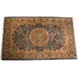 A SILK KASHAN STYLE LIGHT BLUE GROUND RUG with foliate decoration to the central roundel, ground and