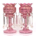 A PAIR OF VICTORIAN PINK GLASS LUSTERS with gilt enamel decoration to the bodies, hanging cut