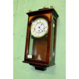 A MODERN MAHOGANY CASED WALL CLOCK with cast brass finials, the three train movement behind a dial