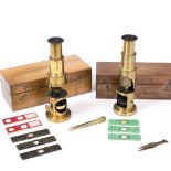 TWO EARLY 20TH CENTURY BRASS LACQUERED MICROSCOPES unsigned, in fitted cases with additional glass