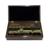A LATE 19TH CENTURY BRASS LACQUERED MICROSCOPE unsigned, in fitted mahogany case with accessories