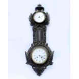 A 19TH CENTURY CAST IRON WALL CLOCK / BAROMETER with an urn finial, acorn and scrolling acanthus