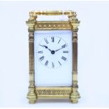 A LATE 19TH / EARLY 20TH CENTURY GILT CASED CARRIAGE CLOCK with pierced floral design case, with
