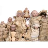 A GROUP OF ANTIQUE CONTINENTAL BISQUE HEADED DOLLS of various sizes, the largest approximately