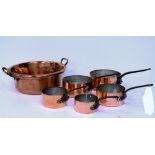 A SET OF FIVE GRADUATED COPPER PANS wit hammered bottoms and a copper jam pan with brass handles,