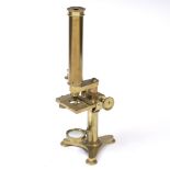 A 19TH CENTURY ADJUSTABLE BRASS MICROSCOPE by W. J. Salmon, on a tripod base, signed 'W.J.