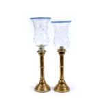 A PAIR OF RUSSIAN BRASS EJECTOR CANDLE STICKS, stamped with a mark beneath and date 1883 49cm high