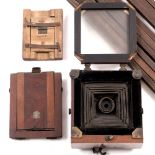 A 19TH CENTURY PLATE CAMERA on tripod base with developing bag, inset with plaque 'Le Merveilleux