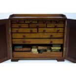 A MAHOGANY WATCHMAKERS CABINET with fielded panelled doors and fitted drawers to the interior and