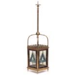 A VICTORIAN BRASS HANGING LANTERN with leaded stained glass panels, 21.5cm wide x 92cm high overall