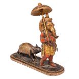 A PAINTED WOODEN FIGURE Mappilai Ganesh carrying a water bottle and leading a rat, with hand painted