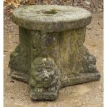 A COMPOSITE STONE STAND of tripod form decorated with animal masks with circular top, 47cm x 37cm