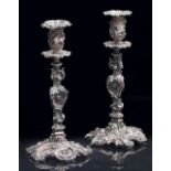 A PAIR OF ANTIQUE SILVER PLATED ROCOCO STYLE CANDLESTICKS possibly by Elkington & Co., each engraved