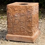 A VICTORIAN TERRACOTTA URN PLINTH of square section, moulded with ivy decoration and with stamped