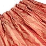 A PAIR OF PLEATED LINEN CURTAINS in striped burnt orange tone (lined), drop measures 137cm x width