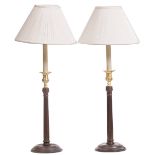 A PAIR OF GEORGIAN STYLE TABLE LAMPS with fluted stems and circular spreading bases standing 65cm